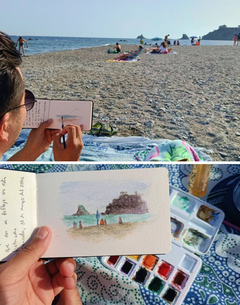 Yohan Pixone pintando una acuarela al aire libre en la playa de Almuñécar durante una práctica de cuaderno de obra.