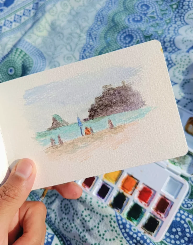 Acuarela de Yohan Pixone realizada en la playa de Almuñécar, con vista del Mediterráneo y figuras frente al mar.