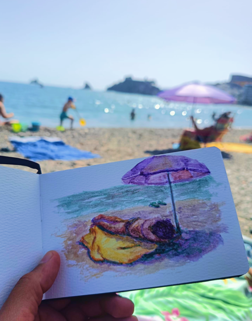 Playa de Almuñécar con sombrilla frente al mar, referencia para una acuarela al aire libre de Yohan Pixone.