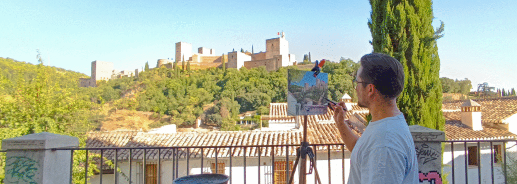 Yohan Pixone pintando plein air frente a la Alhambra de Granada durante una sesión de Laboratorio de Campo